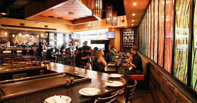 Interior, Teppanyaki tables, dining tables with guests dining, staff in action