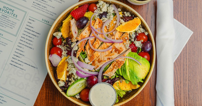 California chicken salad with avocado, strawberries, grapes, cheese, and onions