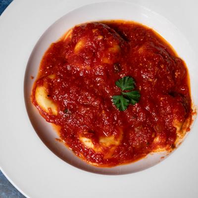 Ravioli smothered in a rustic tomato-based marinara sauce.