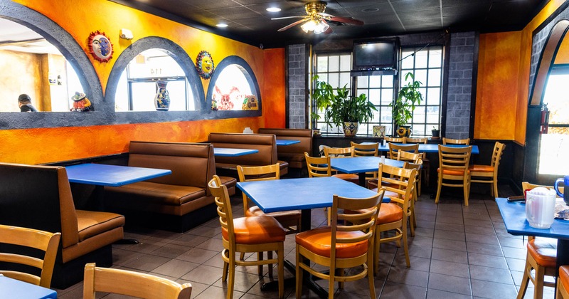A bright, colorful restaurant interior with orange and blue decor