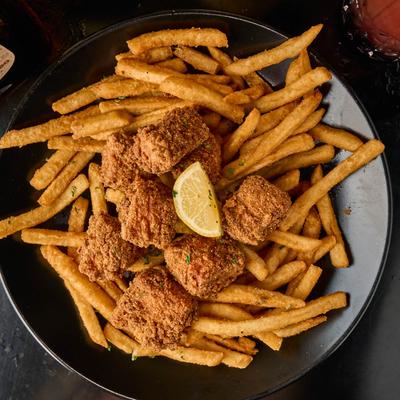 Chicken tenders with fries and a lemon slice.