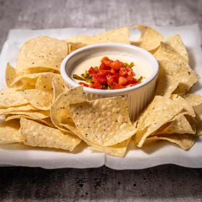 Tortilla chips served with a bowl of dip.