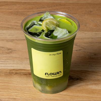 Matcha Lemon Tonic served in a labeled plastic cup with ice and lemon slices.