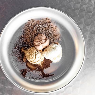 Chocolate, vanilla, and coffee ice cream scoops, on a plate.