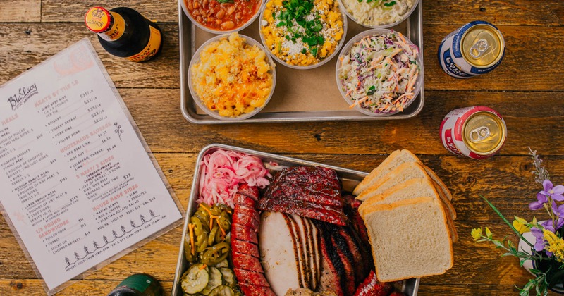 BBQ meat platter and a tray with side dishes, top view