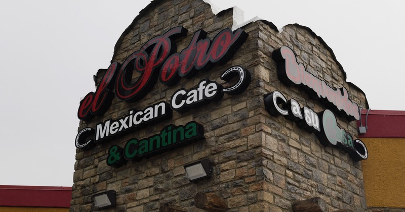 Exterior, light sign above the entrance, stone wall