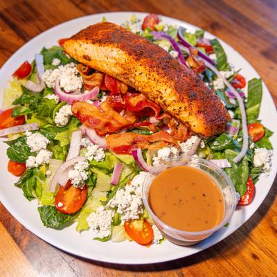 Salmon black and bleu salad, served, top view.
