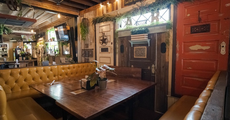 Interior, long button tufted banquette seating with tables