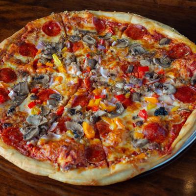 Pizza topped with pepperoni, mushrooms, red onions, and colorful bell peppers.