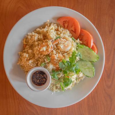Shrimp fried rice with cucumber, tomato, cilantro garnish, and chili dipping sauce.