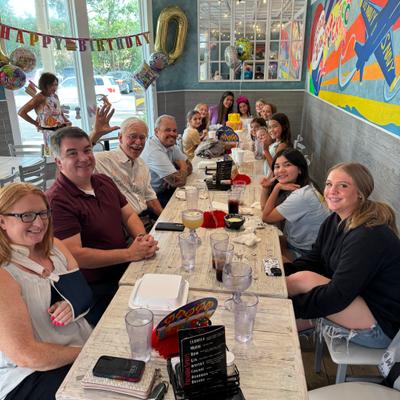 People sitting at joining tables.