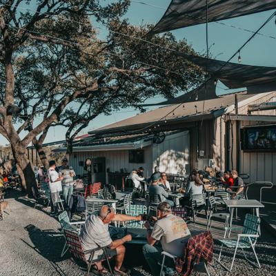 Outdoor seating area, customers eating and drinking.