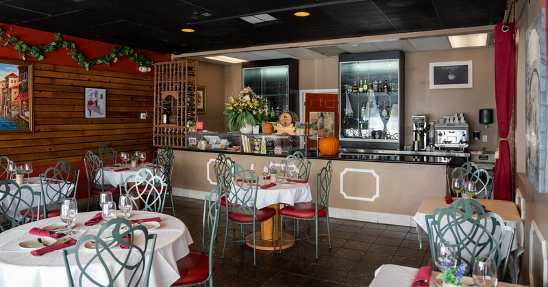 Interior, tables, chairs, counter, wall decorations, glass display cases, drink bottles