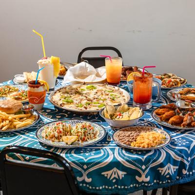 Various dishes served on the table alongside cocktails.