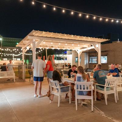 Outdoor seating area, customers having drinks.