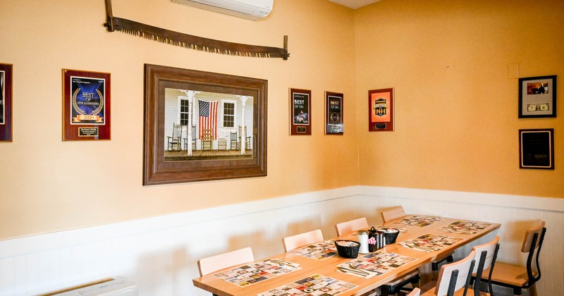 Interior, table and chairs, framed pictures on the walls