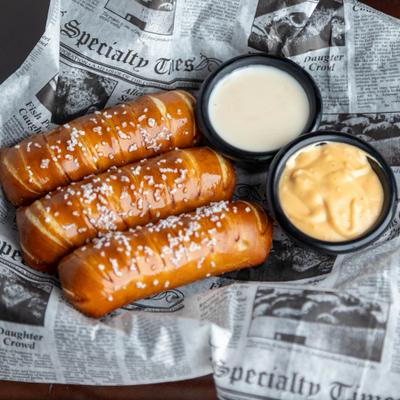 Three Bavarian pretzels served with two dripping sauces.