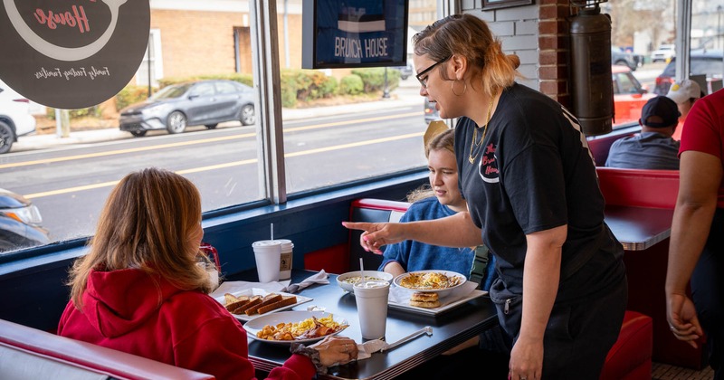 A staff member servicing guests