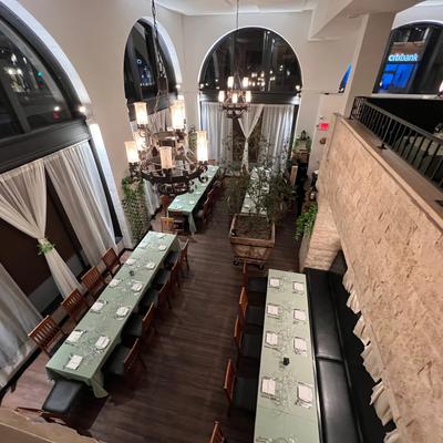 View of ground floor dining room with large tables setup.