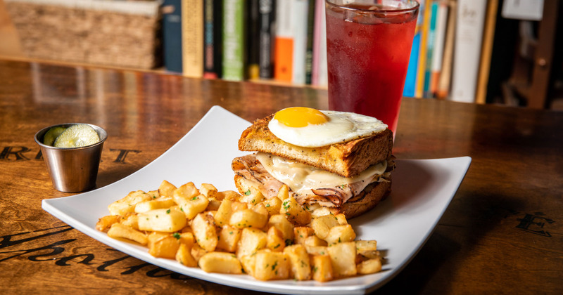 Double sandwich with fried egg, baked potato on the side