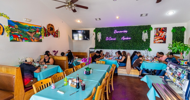Interior, diner area, tables, chairs, booths, guests, wide view
