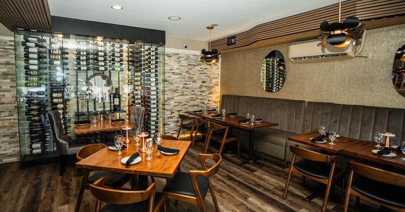 Interior, dining area, wooden top tables with wooden chairs, banquette benches