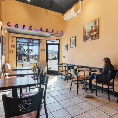 Interior with tables, chairs and a view at the entrance.