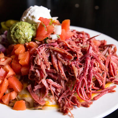 Irish Nachos. A heap of corned beef, tomatoes, red onion, jalapenos, sour cream, guacamole and pico de gallo