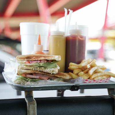 tray of food hanging on car window.