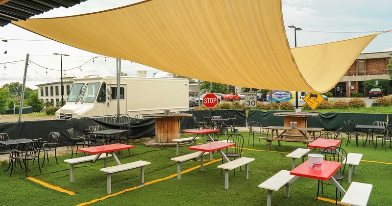 Exterior, patio, tables and seating, covered with sun shade sail