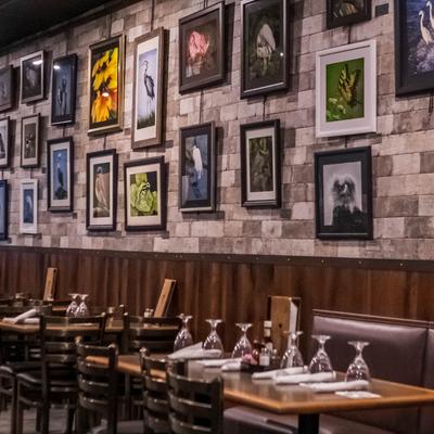 Interior, tables and chairs and pictures on the wall.