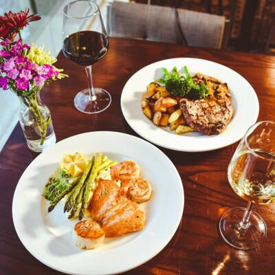 Seared chicken breasts and scallops, Grilled steak and potatoes, and white and red wine.