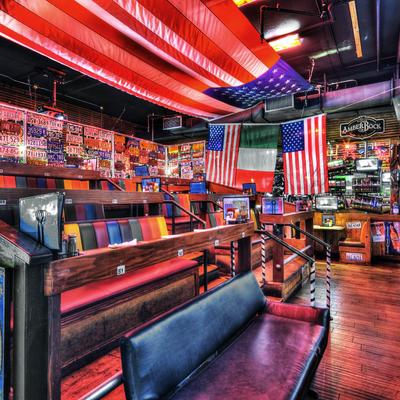 Interior with American  flags, colorful booths, and vintage license plates on walls