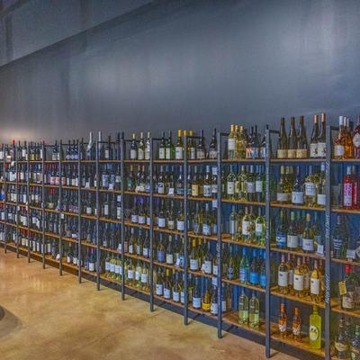Numerous bottles on shelves.