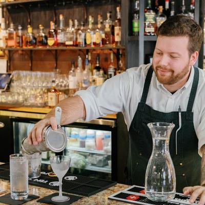 Bartender pouring a cocktail drink.