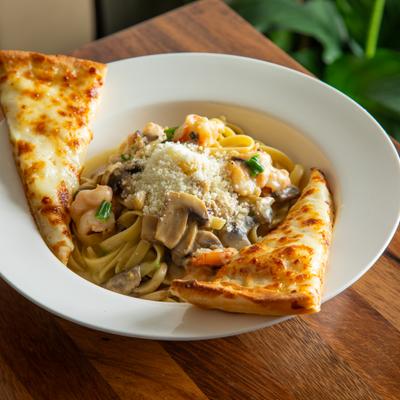 Shrimp Fettuccine with mushrooms and scallions, served with cheesy bread.