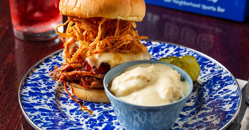 Pulled pork sandwich with bacon, crispy onion strings, BBQ sauce and pepper jack cheese