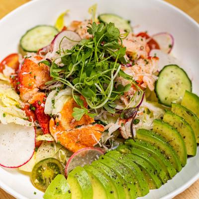 Lobster Salad, with iceberg lettuce, radish, avocado, fennel, cucumber, and tomatoes.