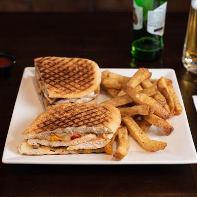 Chicken sandwich  and fries, with beer.