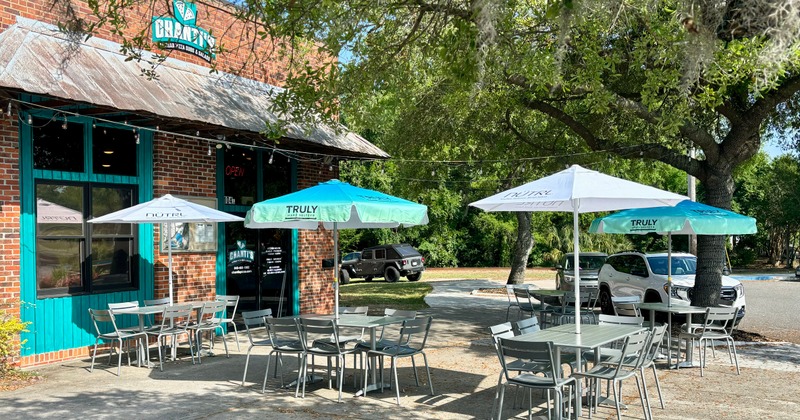 Exterior. outdoor seating area with tables and parasols