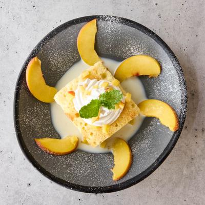 Tres Leches cake, with peach slices.