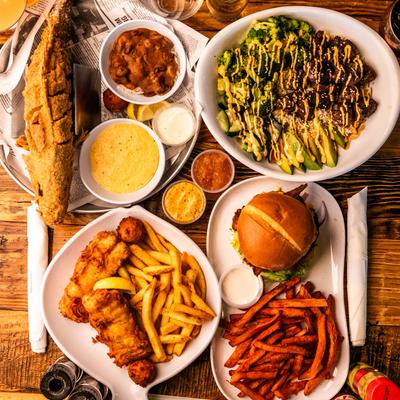 A variety of dishes arranged on a wooden table.