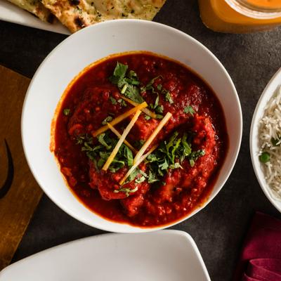 Boneless chicken and potatoes in hot sauce with herbs and spices.