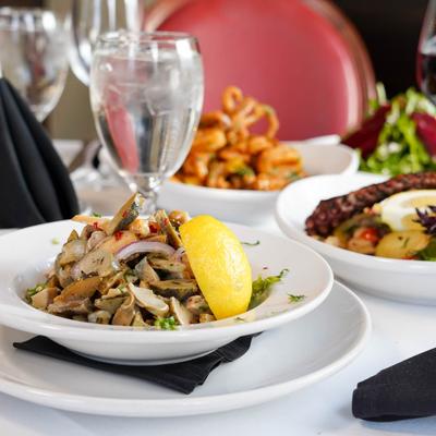 Snail salad with different dishes on the table.