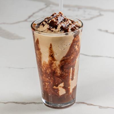 Creamy milkshake topped with chocolate drizzle.