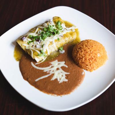 Enchiladas Verdes served with rice and refried beans.