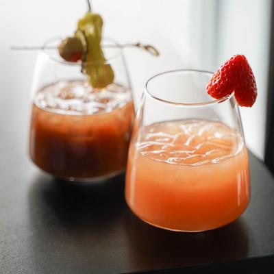 Grapefruit Mimosa garnished with a strawberry and Bloody Mary garnished with olives and peppers.