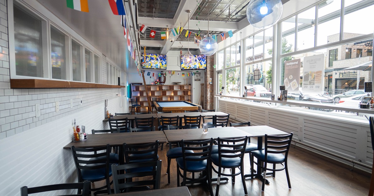 Interior, seating area, tables for ten, pool table in the back, large windows