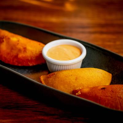 Empanadas with a sauce.