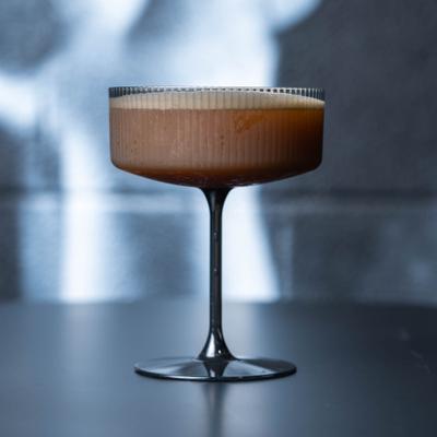 Espresso Martini cocktail in a ribbed glass coupe.